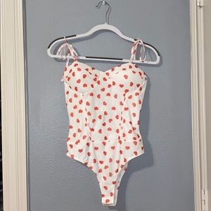 white bodysuit with red hearts